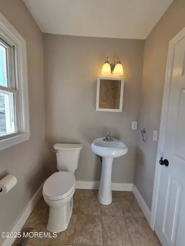 a white toilet sitting next to a bathroom sink