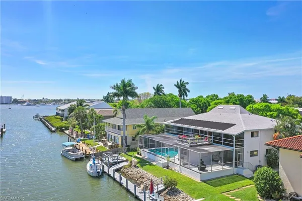 an aerial view of a house with swimming pool garden and patio