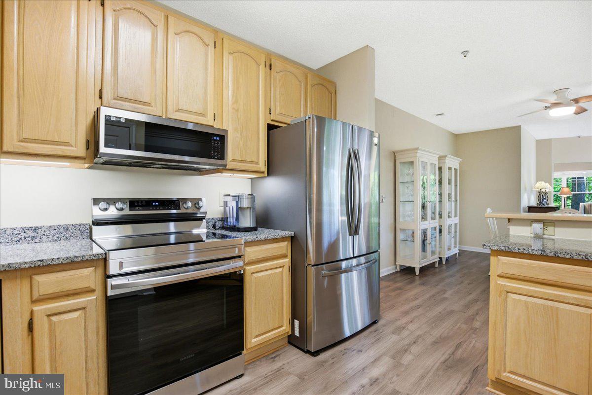 1126 Back Creek Loop, Unit 1126 Solomons, MD 20688 - Photo 12 of 47 a kitchen with stainless steel appliances granite countertop a refrigerator stove and sink