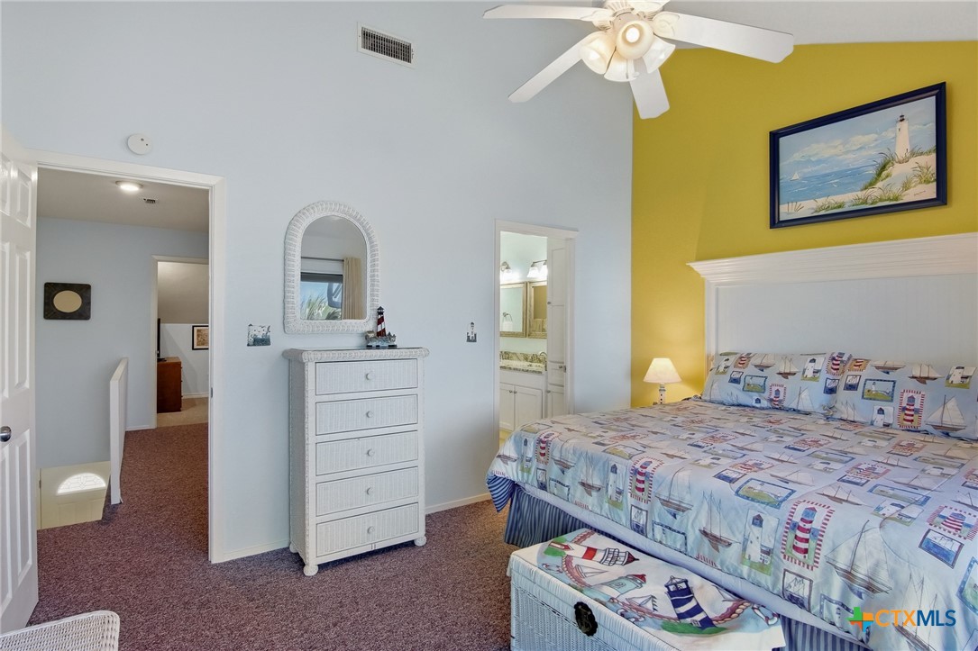 2292 North Fulton Beach Road, Unit 505 Rockport, TX 78382 - Photo 23 of 46 a bedroom with a bed and a dresser