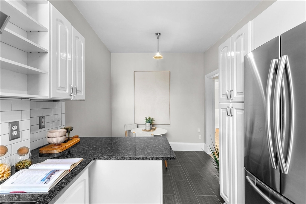 9 Verndale Street, Unit 2 Brookline, MA 02446 - Photo 16 of 39 a kitchen with stainless steel appliances granite countertop a refrigerator a sink and white cabinets