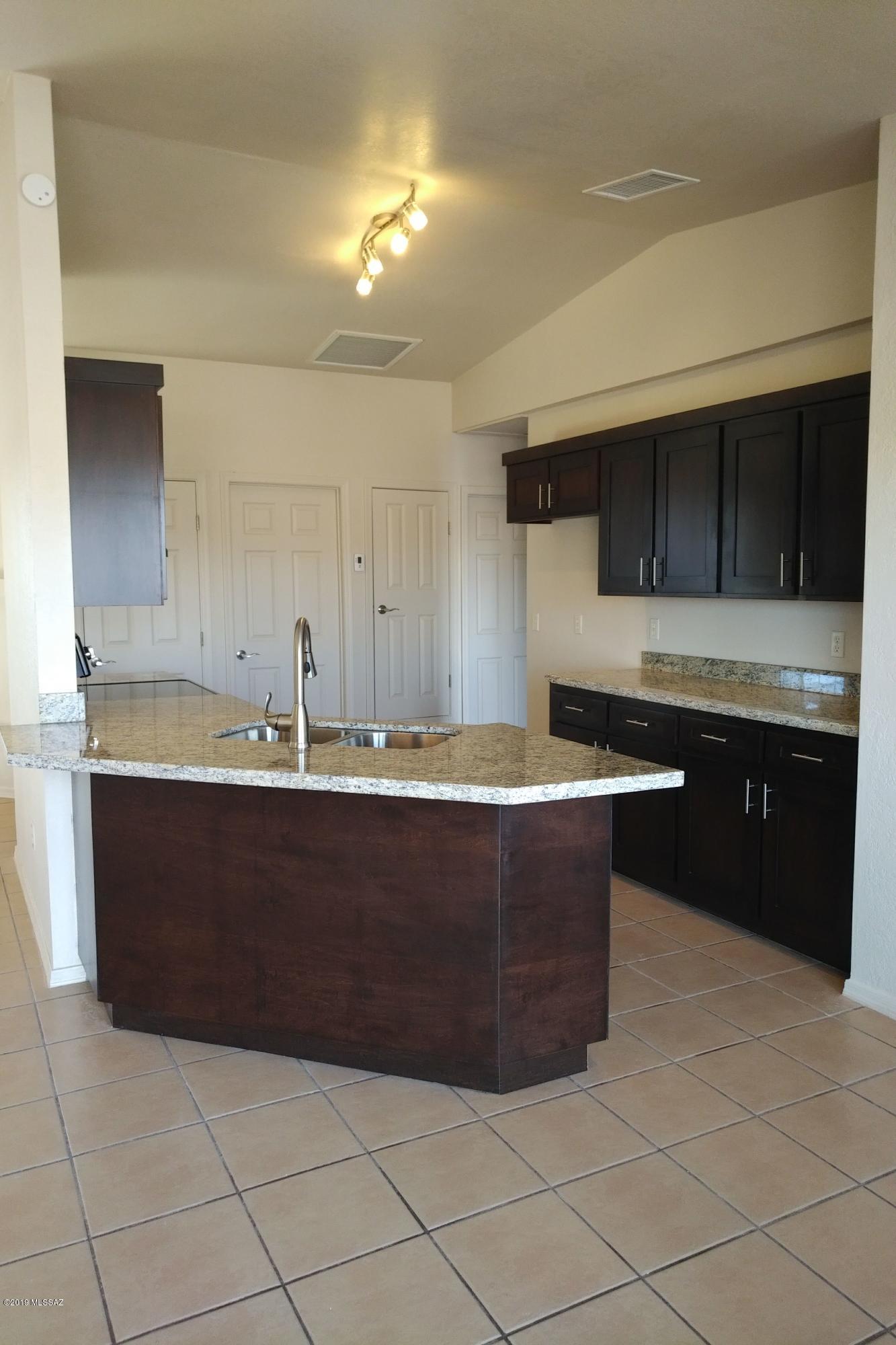 266 Mirto Court Rio Rico, AZ 85648 - Photo 12 of 22 a view of kitchen with stainless steel appliances granite countertop a sink and a stove