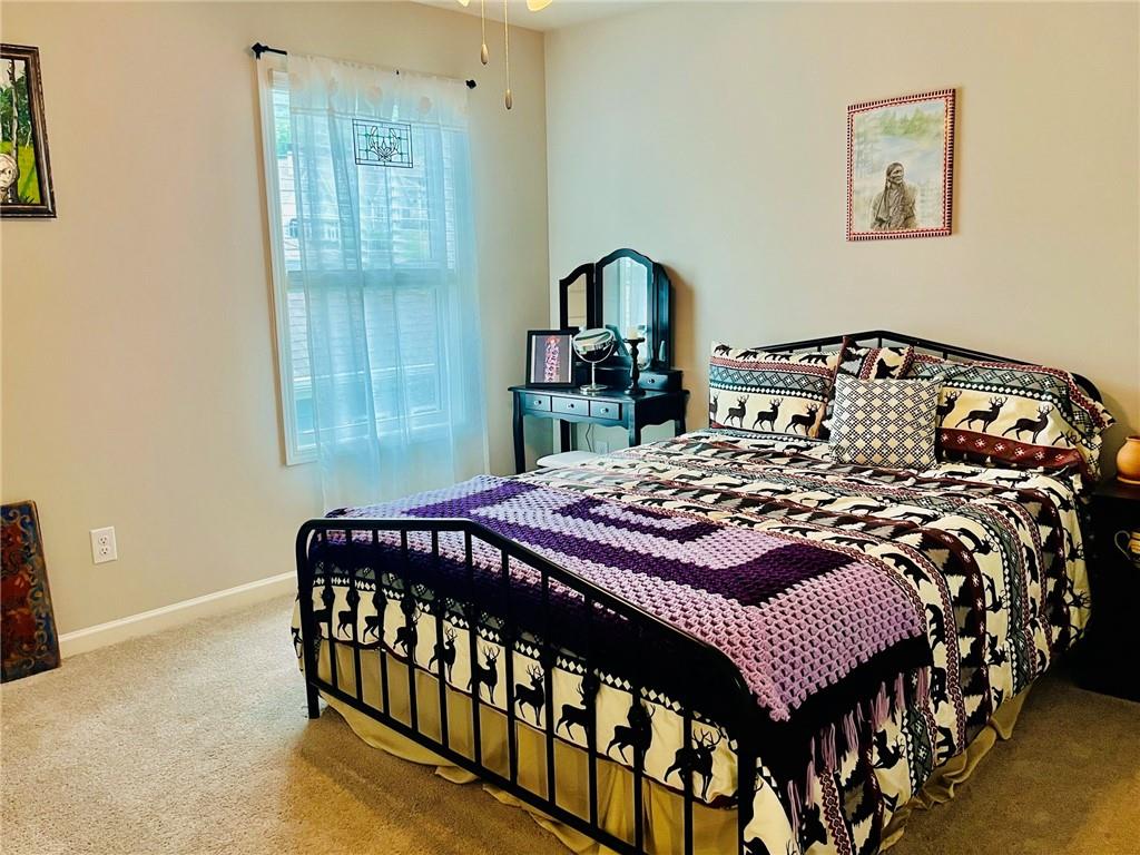 3015 Winding Ridge Waleska, GA 30183 - Photo 32 of 40 a bedroom with a bed a mirror on dresser and a window