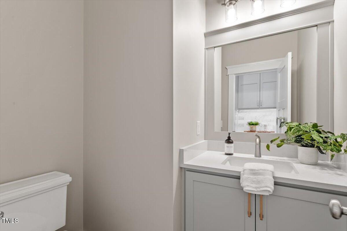 3932 Old Chapel Hill Road Durham, NC 27707 - Photo 20 of 46 a bathroom with a sink a toilet and a mirror