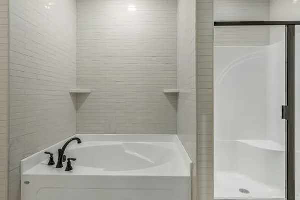 a bathroom with a bathtub and shower