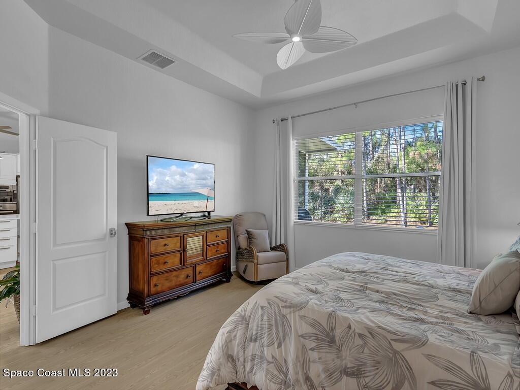 5621 Spanish River Road Fort Pierce, FL 34951 - Photo 13 of 34 a bedroom with a bed and a chandelier