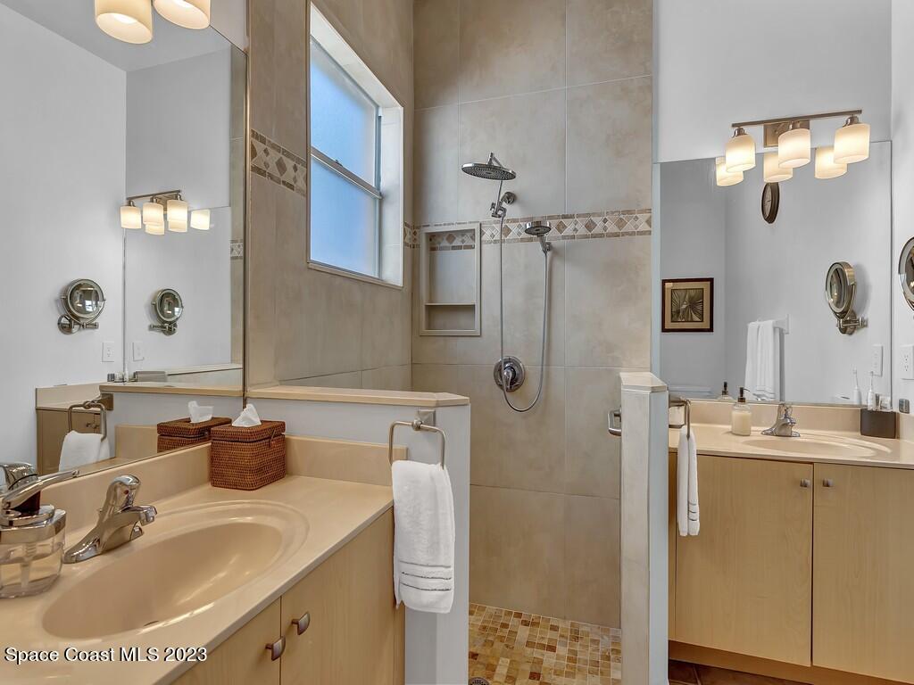 5621 Spanish River Road Fort Pierce, FL 34951 - Photo 14 of 34 a bathroom with a sink vanity granite tub and shower