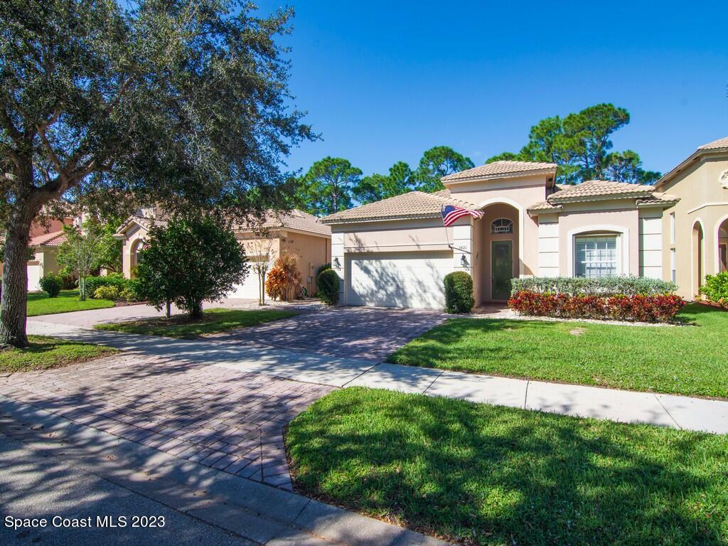 5621 Spanish River Road Fort Pierce, FL 34951 - Photo 18 of 34 a view of a white house with a yard and plants