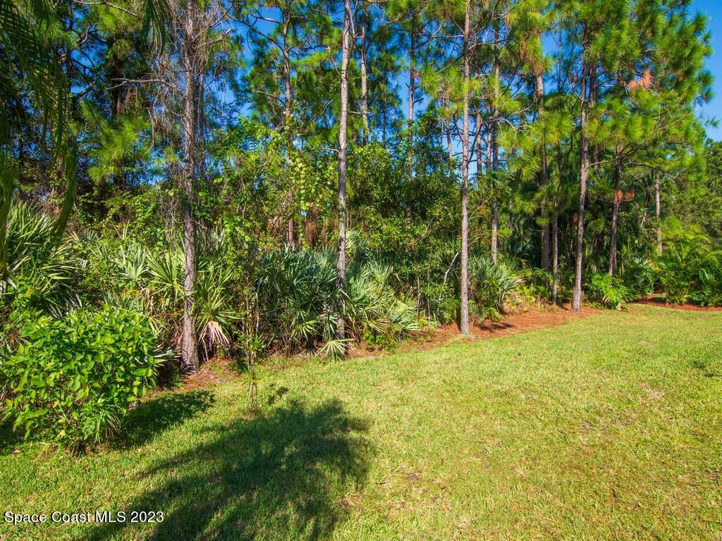 5621 Spanish River Road Fort Pierce, FL 34951 - Photo 21 of 34 a view of swimming pool with a bench and trees