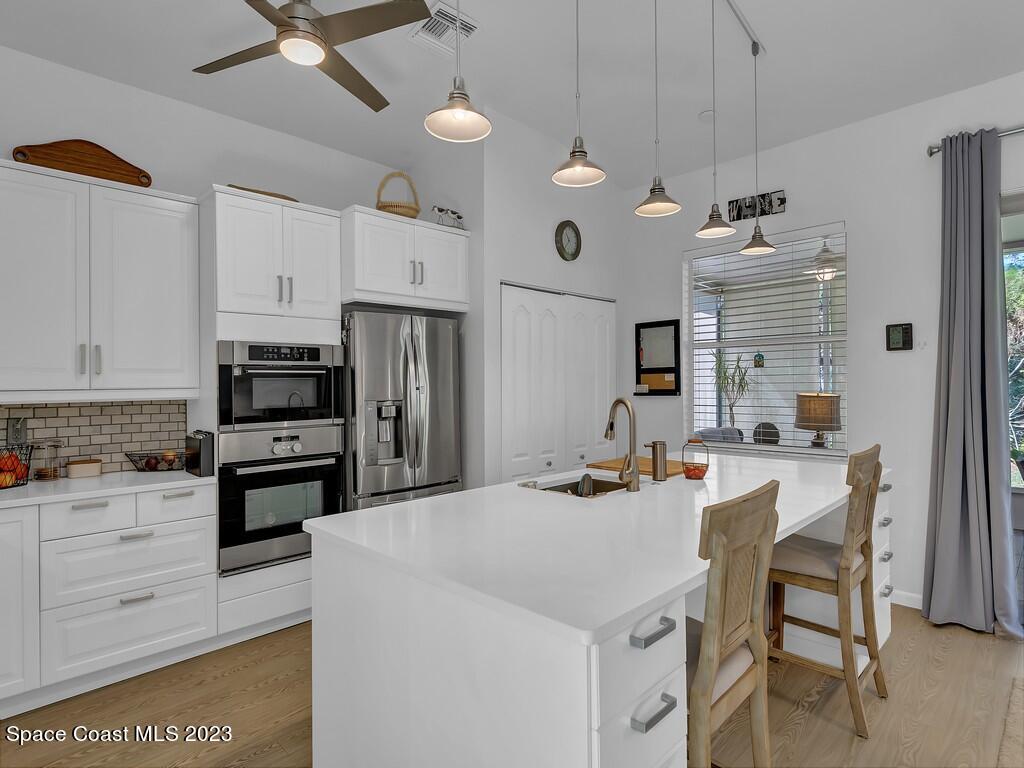 5621 Spanish River Road Fort Pierce, FL 34951 - Photo 8 of 34 a kitchen that has a lot of cabinets a sink and appliances
