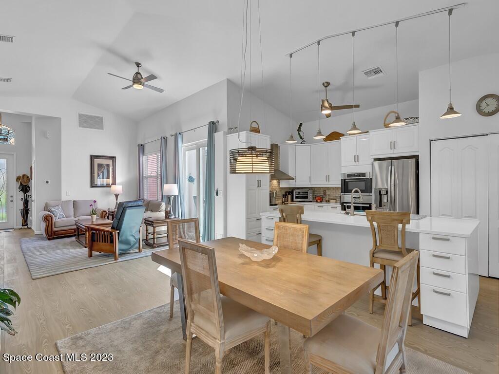 5621 Spanish River Road Fort Pierce, FL 34951 - Photo 10 of 34 a open kitchen view with white cabinets and couches