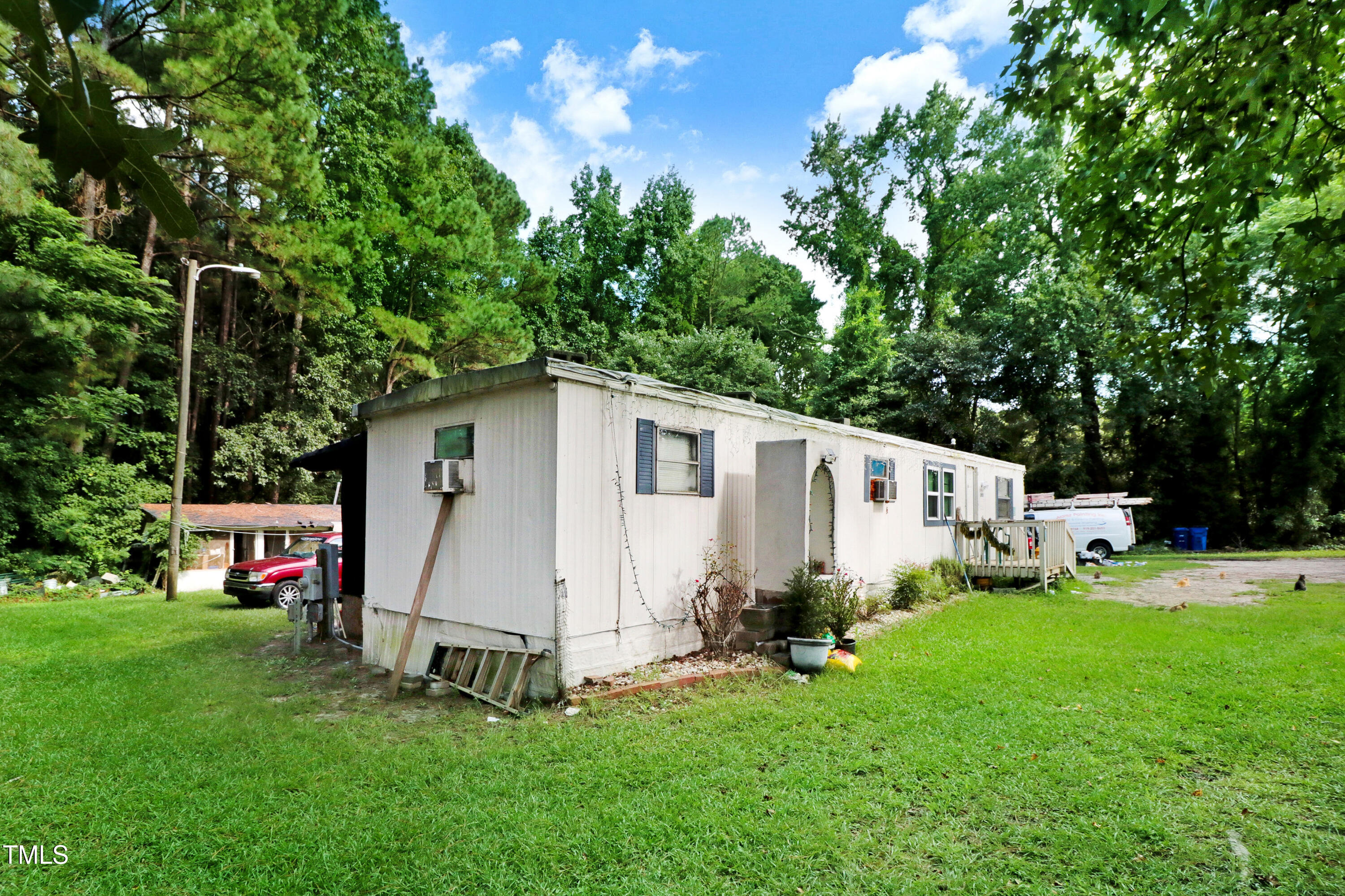 2057 Old Rock Quarry Road Princeton, NC 27569 - Photo 3 of 7 a view of a white house with a big yard and large trees