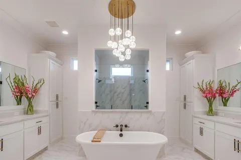 a bathroom with a sink a large mirror and a shower
