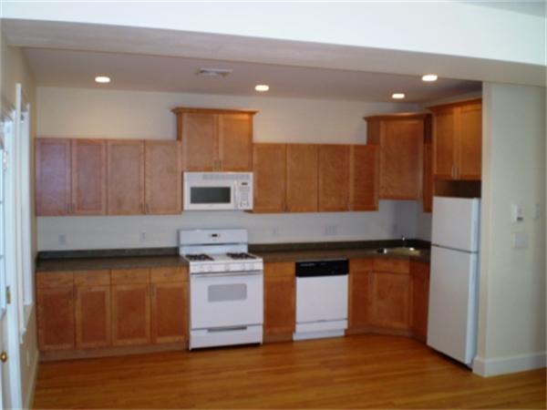 111 Heath Street Boston, MA 02120 - Photo 11 of 17 a kitchen with stainless steel appliances granite countertop a stove a sink and a refrigerator