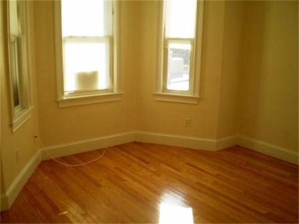 111 Heath Street Boston, MA 02120 - Photo 5 of 17 a view of an empty room with a window and wooden floor