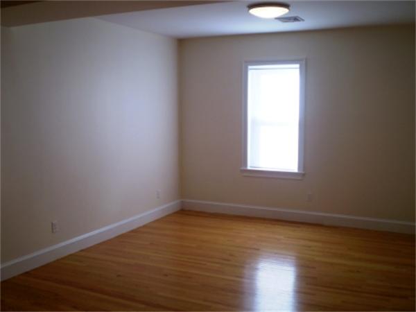 111 Heath Street Boston, MA 02120 - Photo 7 of 17 a view of an empty room with wooden floor and a window