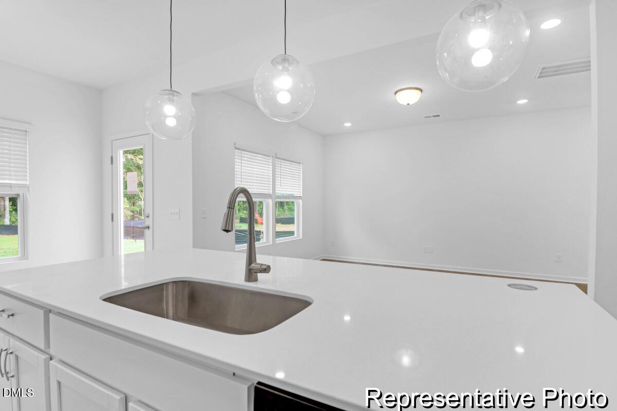 40 Birchstone Trail, Unit 225P Erwin, NC 28339 - Photo 12 of 26 a kitchen with a sink and a large mirror