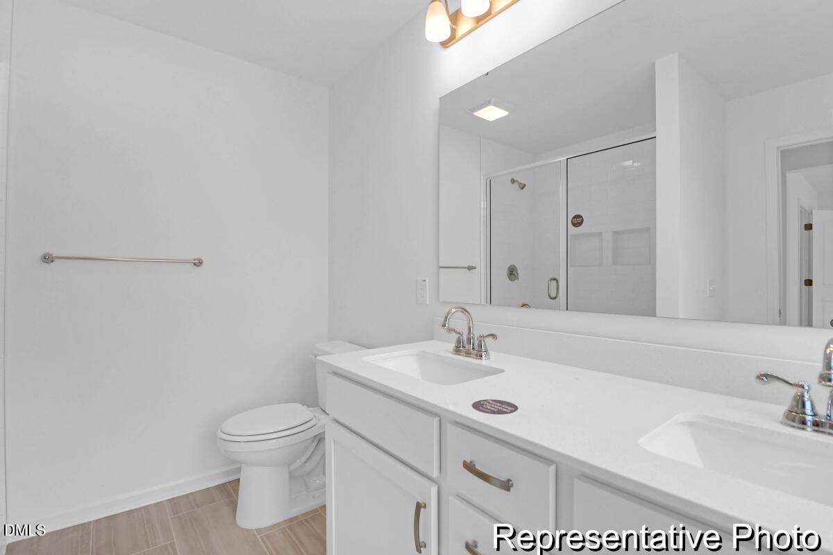 40 Birchstone Trail, Unit 225P Erwin, NC 28339 - Photo 21 of 26 a bathroom with a sink toilet and vanity