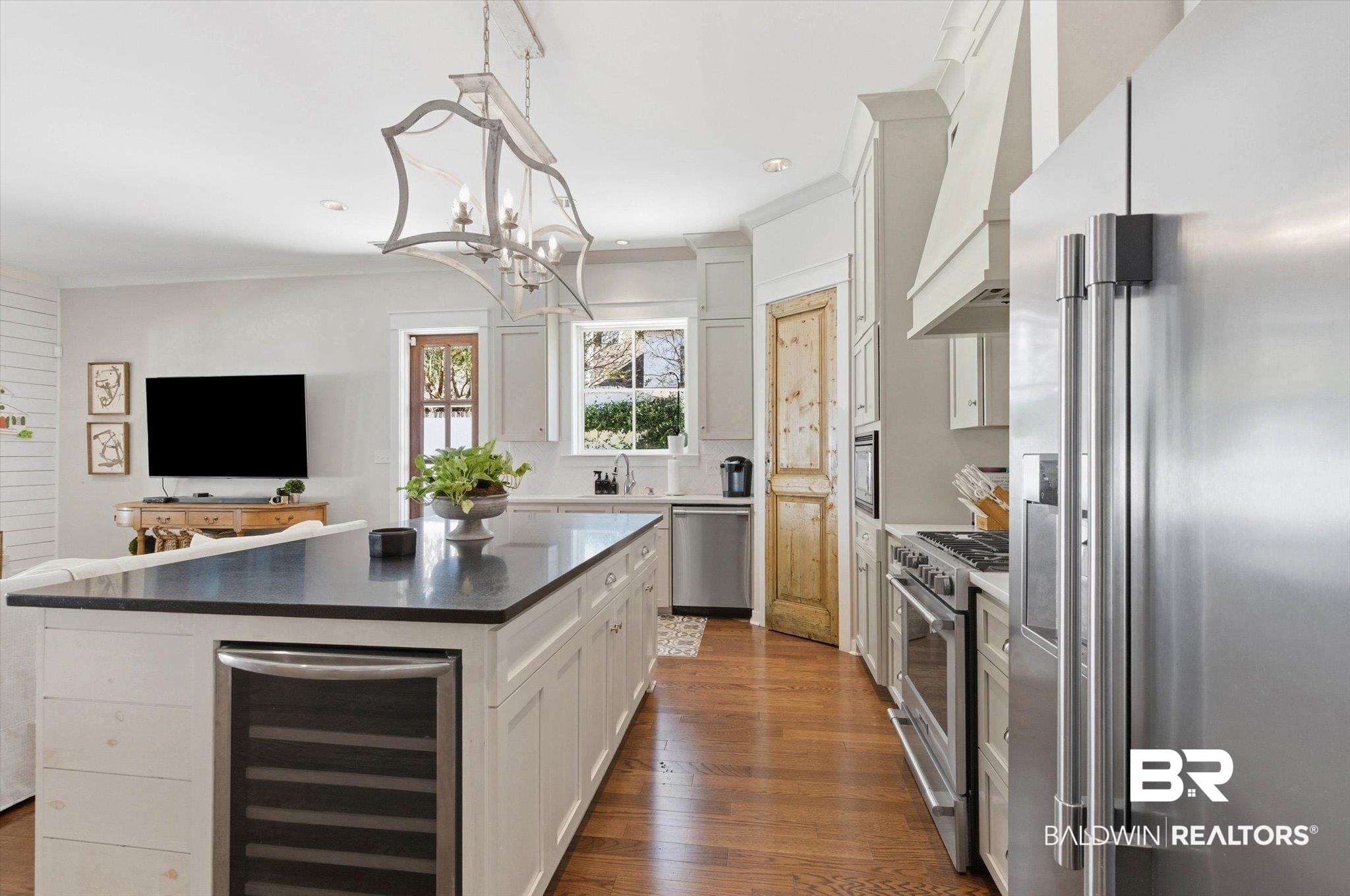 3704 Stein Street Mobile, AL 36608 - Photo 34 of 37 Kitchen with high end appliances, white cabinetry, wine cooler, open floor plan, and dark wood-style floors