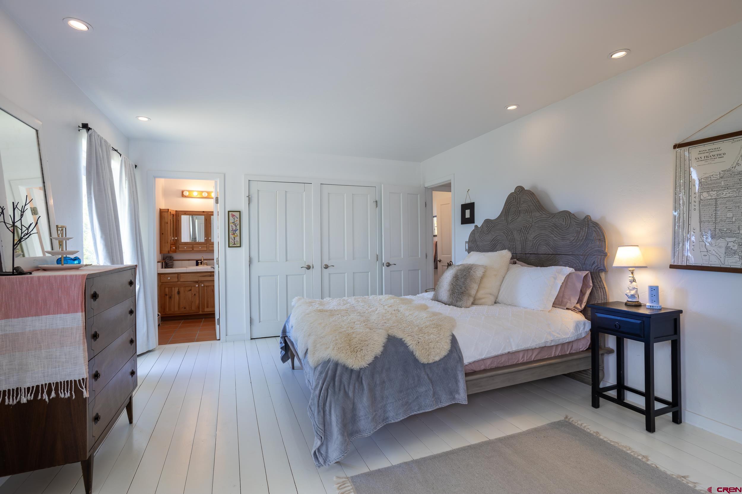 42224 Foothills Road Paonia, CO 81428 - Photo 16 of 40 a spacious bedroom with a bed and a lamp