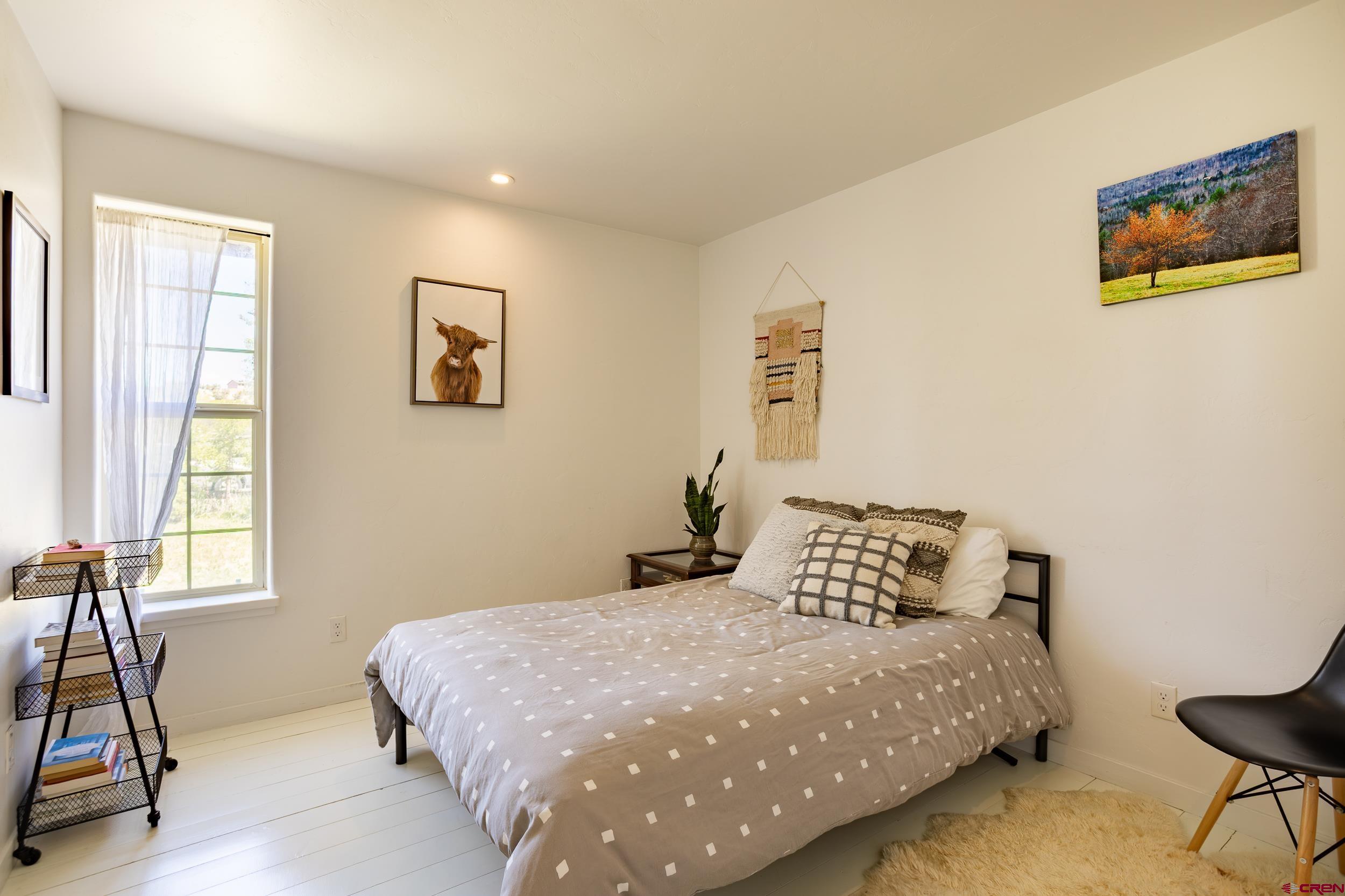 42224 Foothills Road Paonia, CO 81428 - Photo 20 of 40 a bedroom with a bed and a painting on the wall
