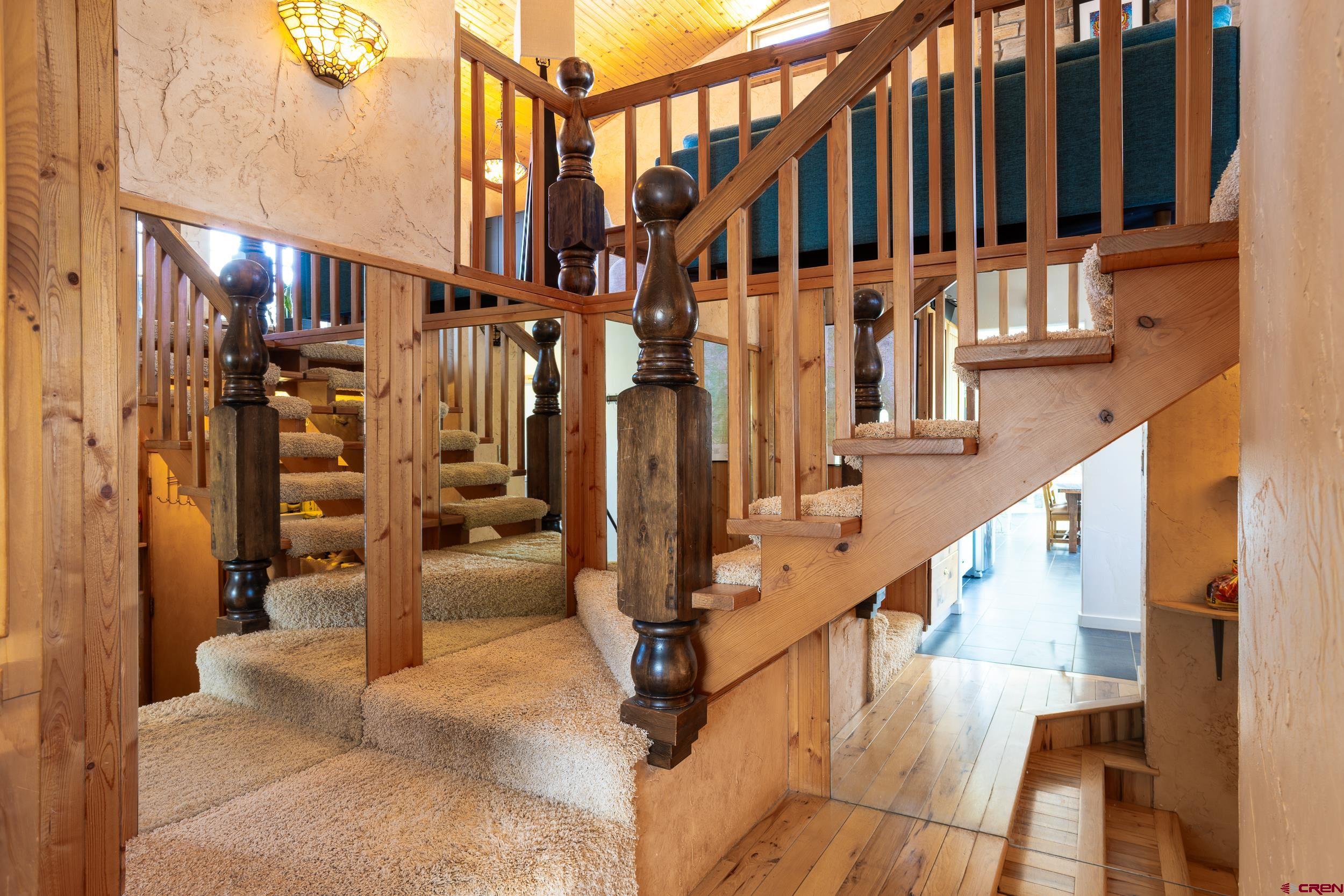42224 Foothills Road Paonia, CO 81428 - Photo 23 of 40 a view of staircase with lots of frames on wall and windows