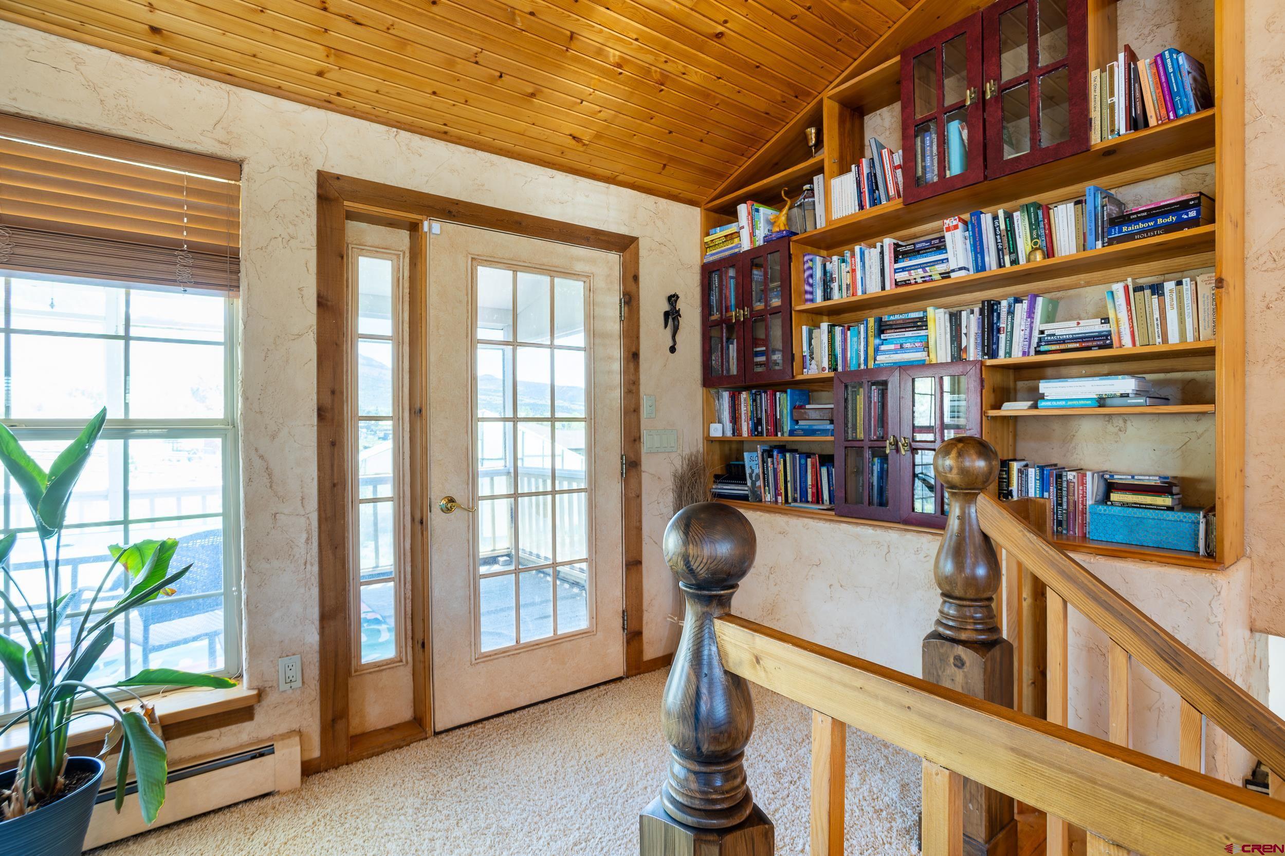 42224 Foothills Road Paonia, CO 81428 - Photo 24 of 40 a view of a workspace with furniture and a book shelf