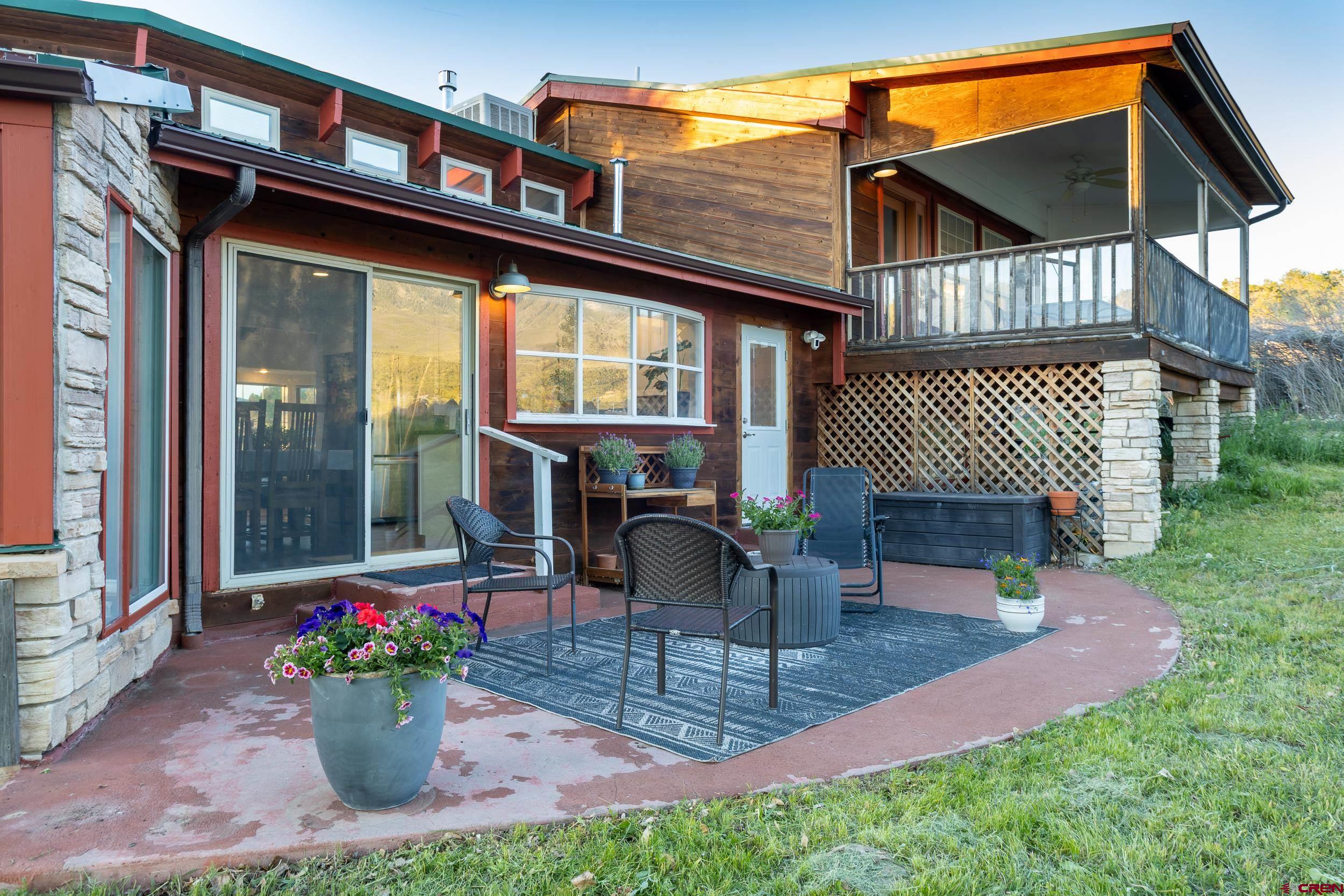 42224 Foothills Road Paonia, CO 81428 - Photo 32 of 40 a view of a chair and tables in the patio in front of a house