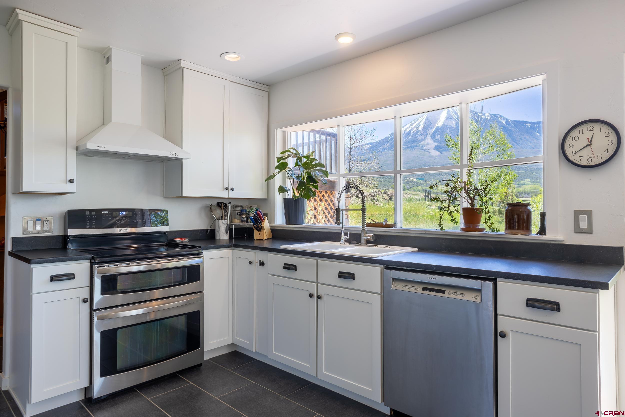 42224 Foothills Road Paonia, CO 81428 - Photo 8 of 40 a kitchen with a sink stove and cabinets