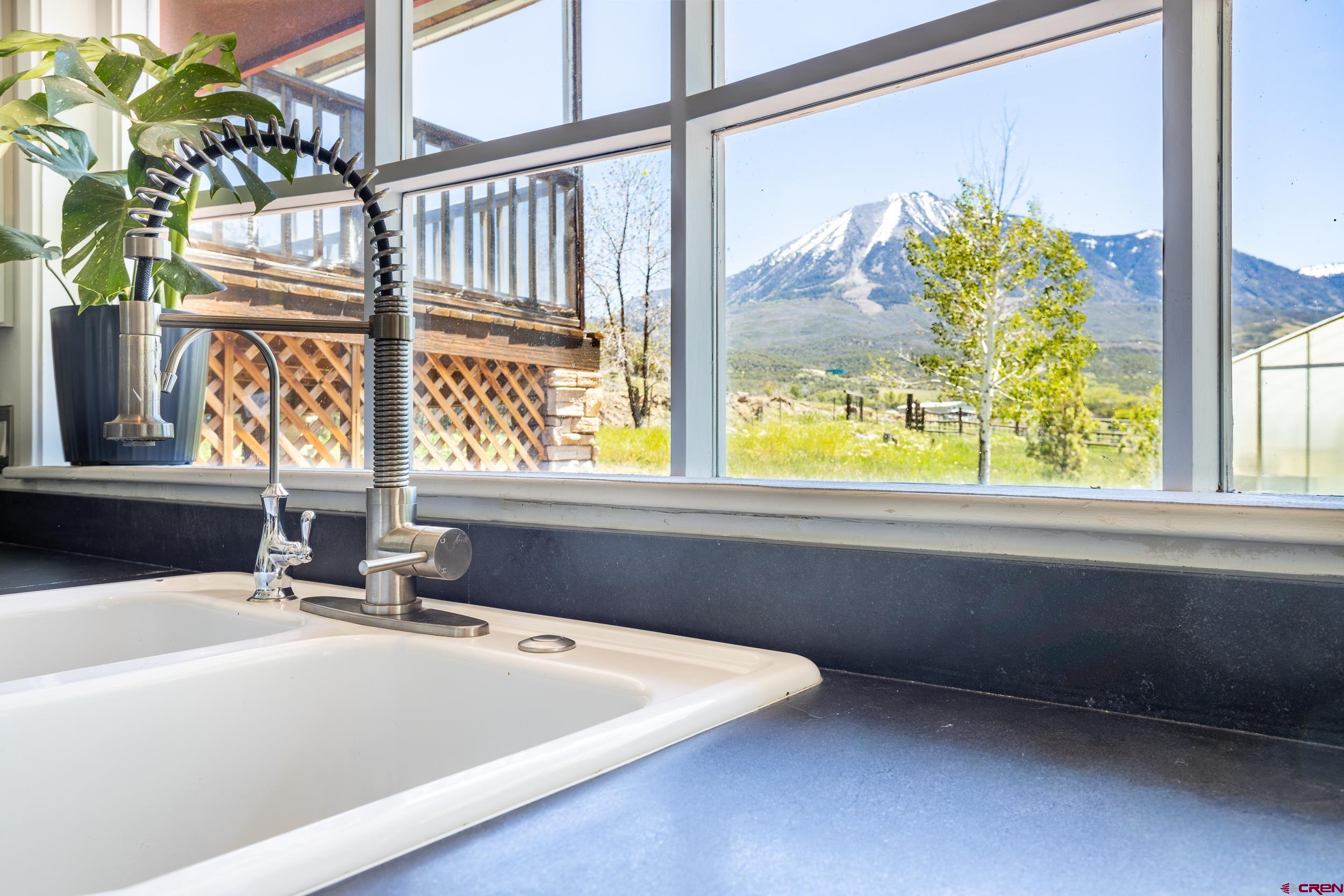 42224 Foothills Road Paonia, CO 81428 - Photo 9 of 40 a bathroom with a granite countertop sink and a large window