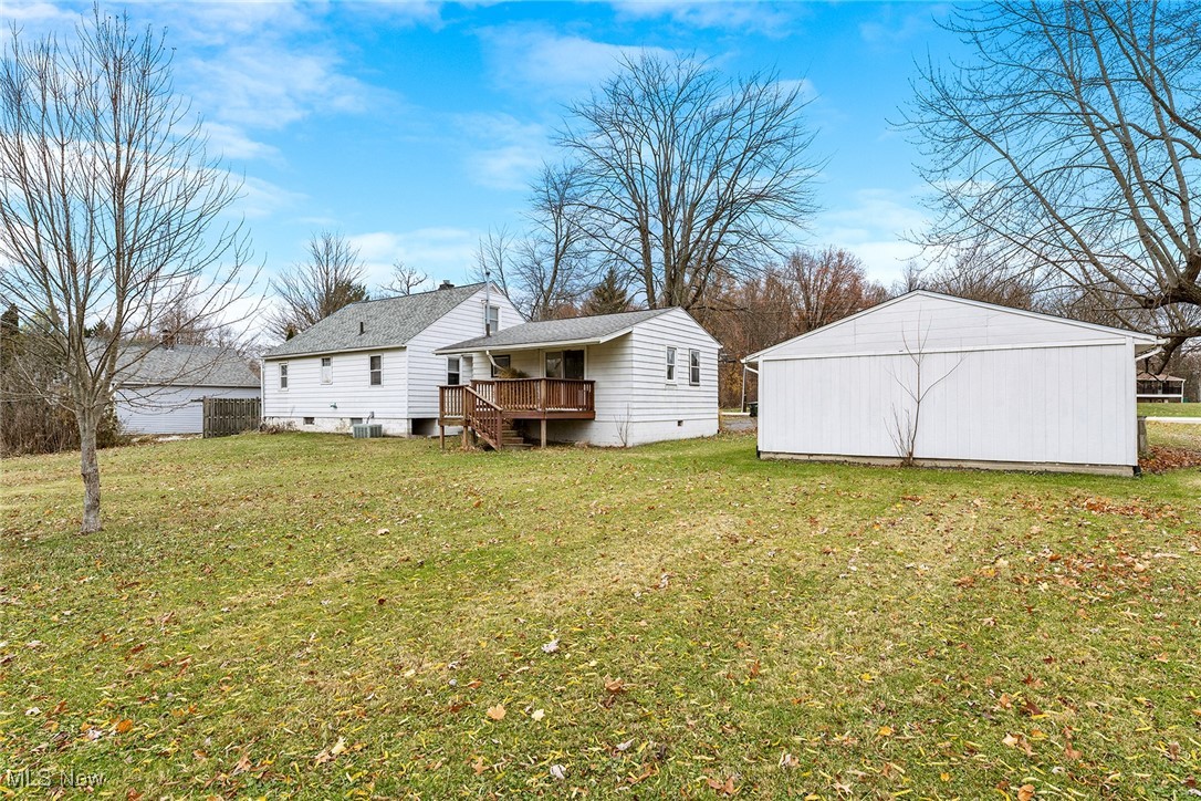4556 Fishcreek Road Stow, OH 44224 - Photo 40 of 41 Back of house with an outdoor structure, a lawn, and a wooden deck