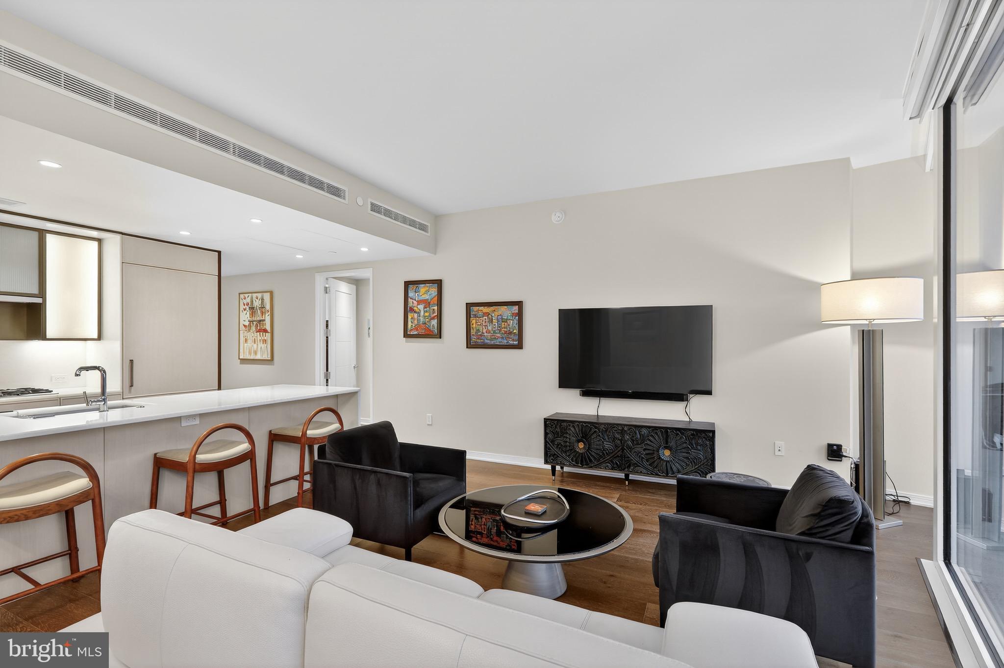 601 Wharf Street Southwest, Unit 1107 Washington, DC 20024 - Photo 14 of 26 a living room with furniture and a flat screen tv