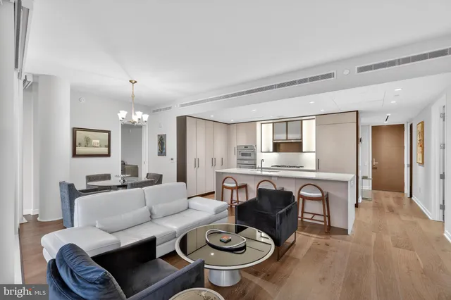 a living room with furniture a dining table and kitchen view