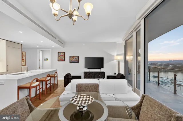 a living room with furniture a rug and a chandelier
