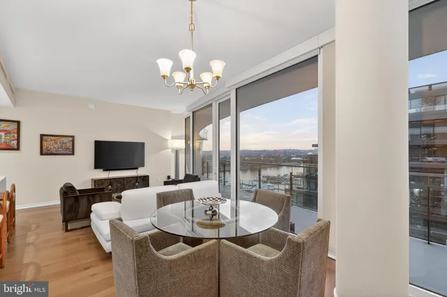 a dining room with furniture a chandelier and window
