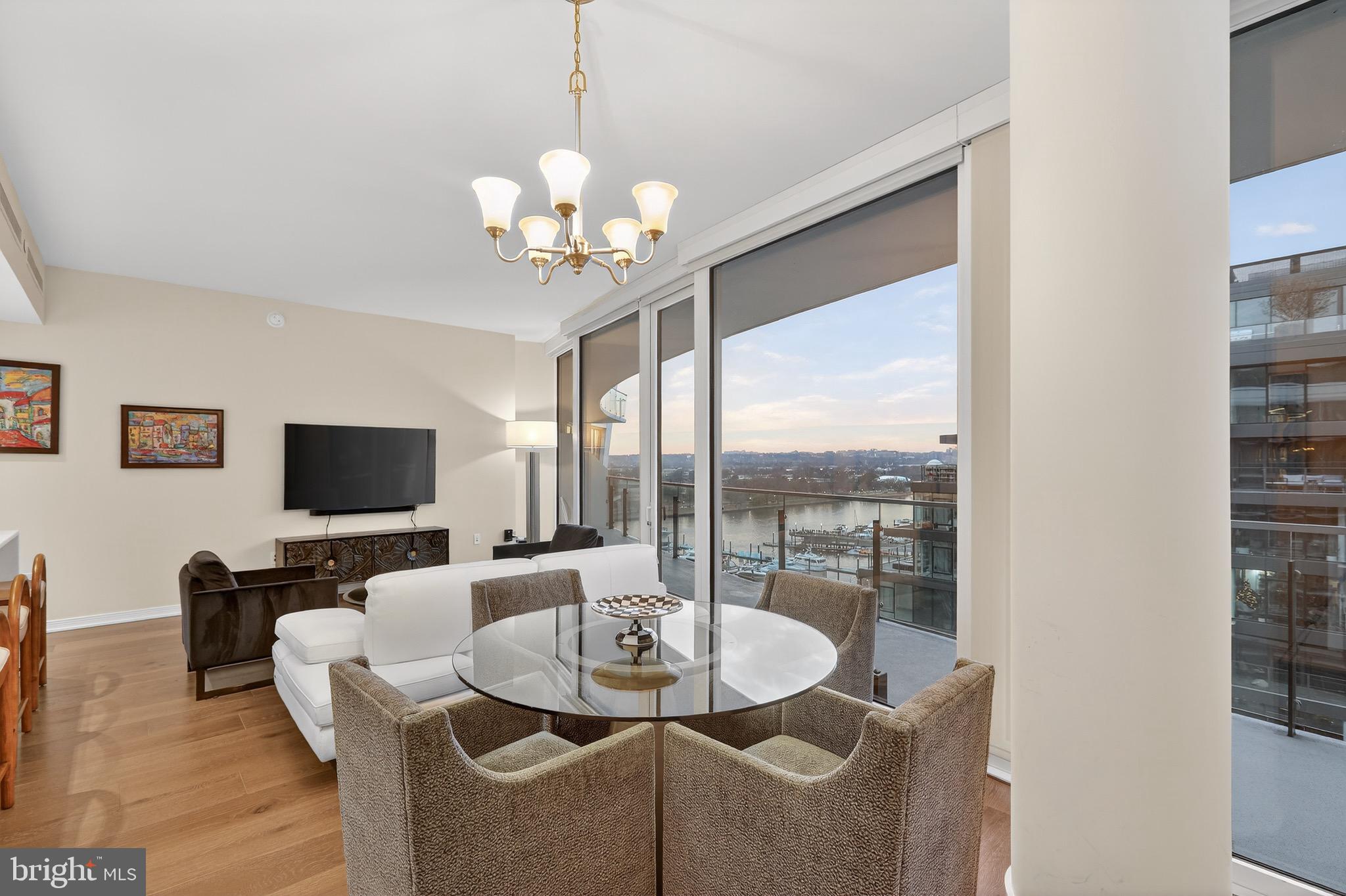 601 Wharf Street Southwest, Unit 1107 Washington, DC 20024 - Photo 17 of 26 a dining room with furniture a chandelier and window