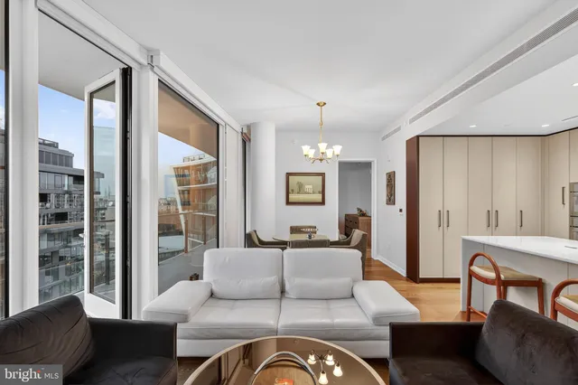 a living room with furniture ceiling fan and a window