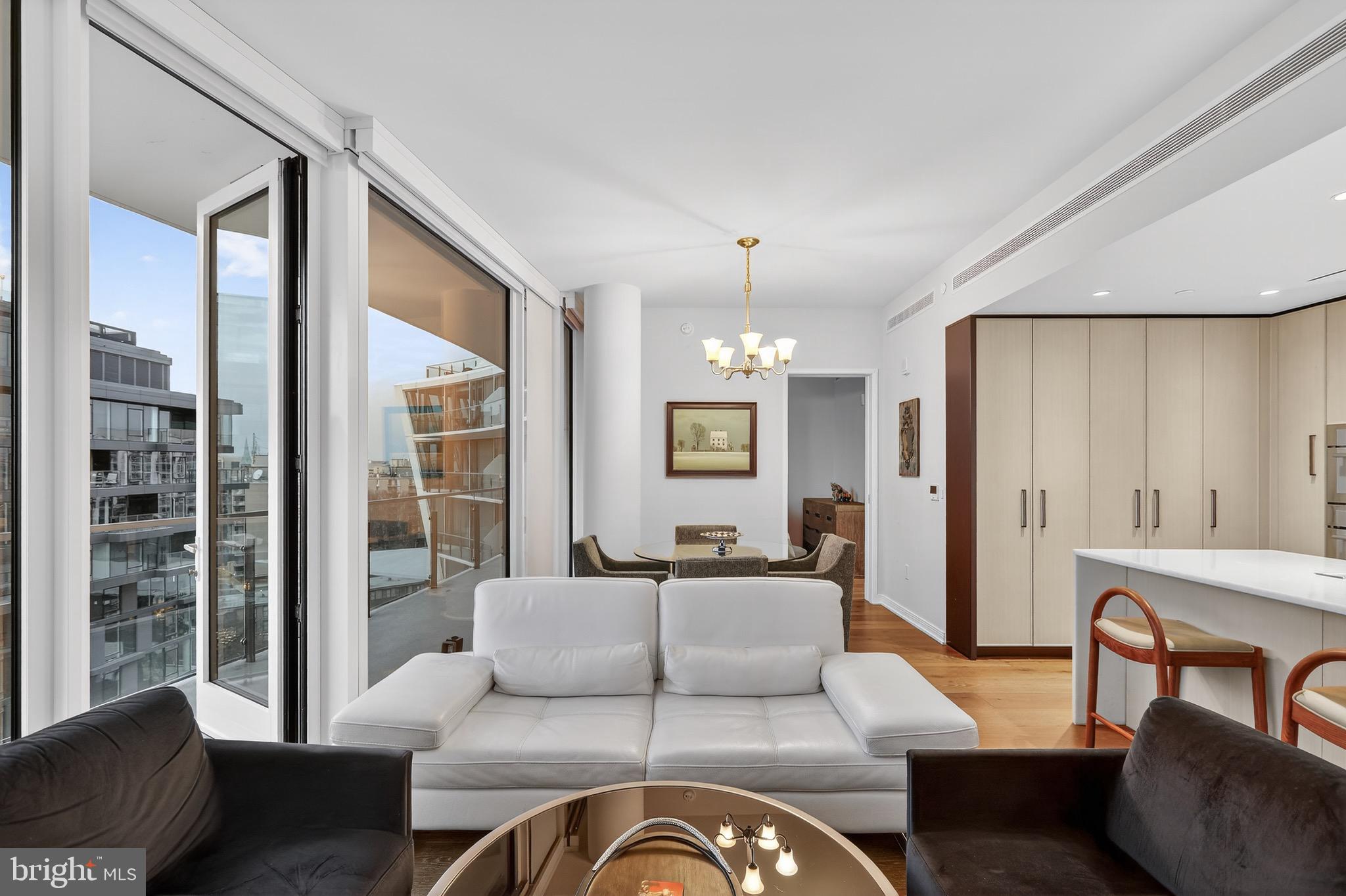 601 Wharf Street Southwest, Unit 1107 Washington, DC 20024 - Photo 18 of 26 a living room with furniture ceiling fan and a window