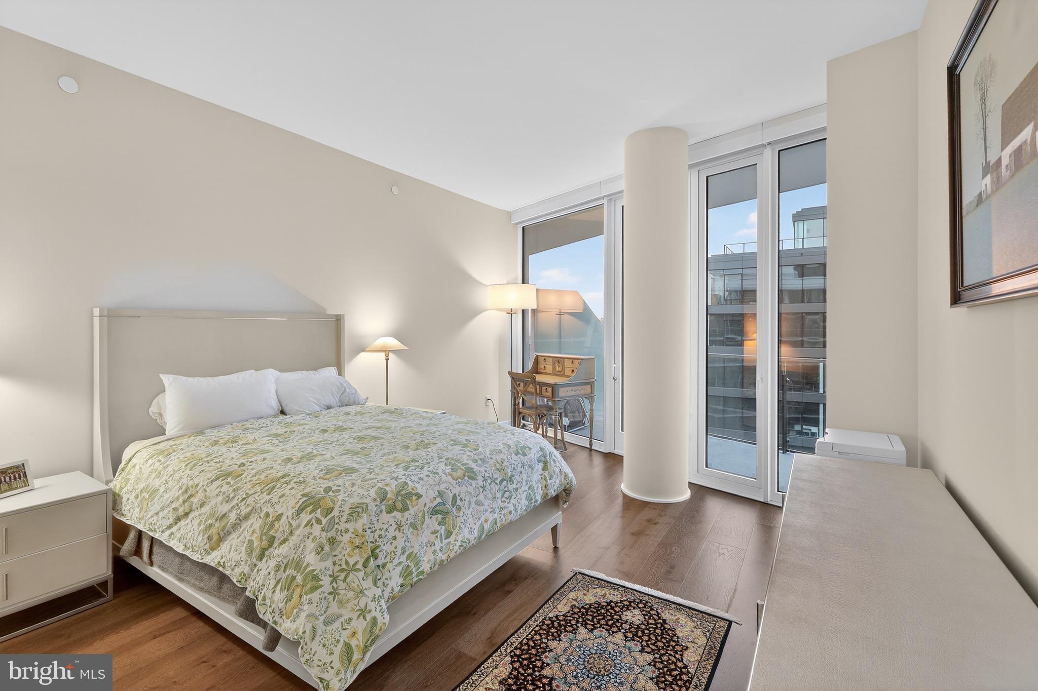601 Wharf Street Southwest, Unit 1107 Washington, DC 20024 - Photo 20 of 26 a bedroom with a bed and wooden floor