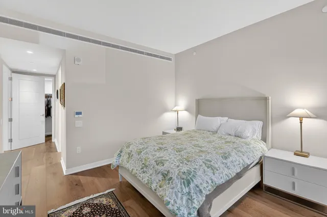 a bedroom with a bed and a lamp