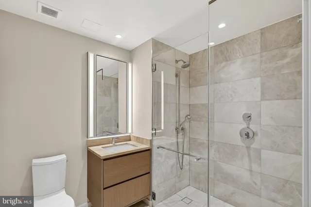 a bathroom with a shower sink and toilet