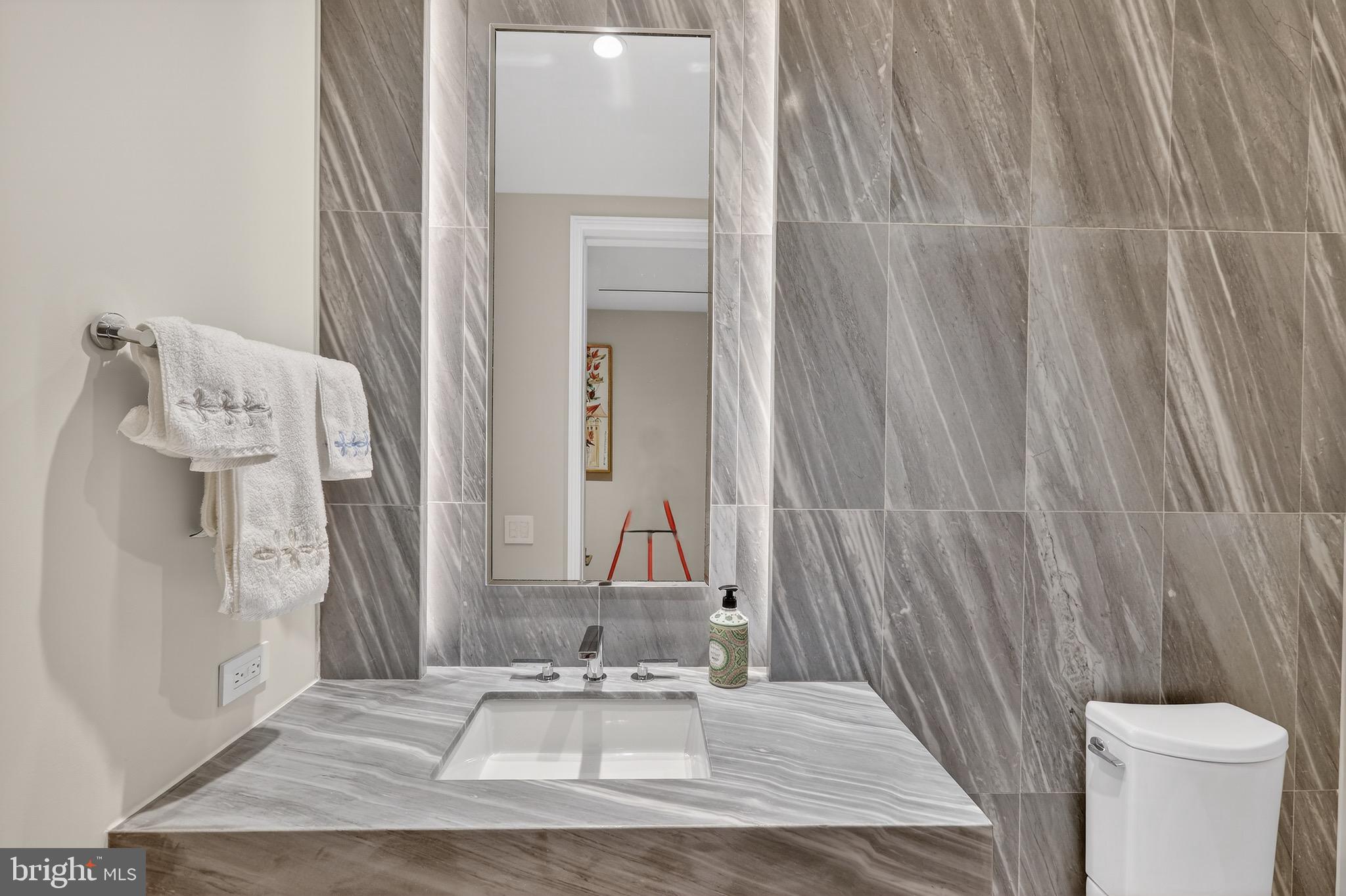 601 Wharf Street Southwest, Unit 1107 Washington, DC 20024 - Photo 25 of 26 a bathroom with a sink and a mirror