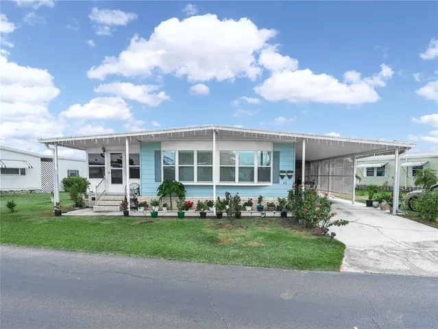 a view of a house with a yard in front of it