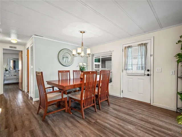 a view of a dining room with furniture wooden floor and a chandelier