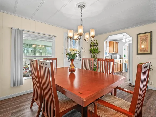 a view of a dining room with furniture wooden floor and chandelier