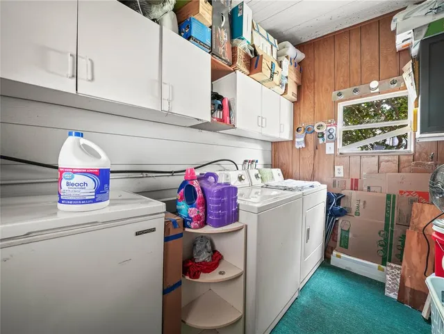 a view of a room that has a bed and a chandelier