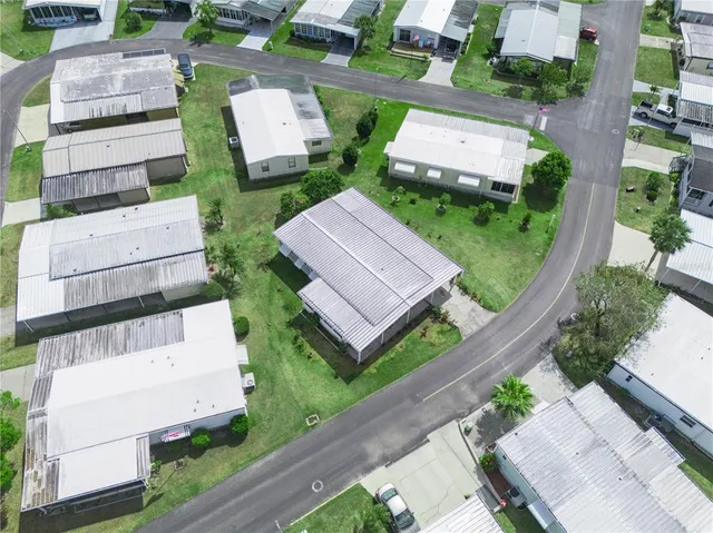 an aerial view of a house with garden space and street view