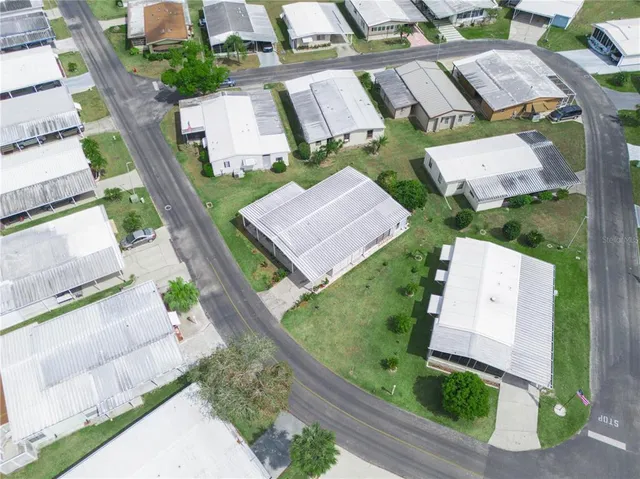 an aerial view of a house with a yard