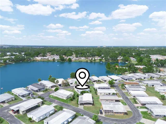 an aerial view of a house with a yard and pool