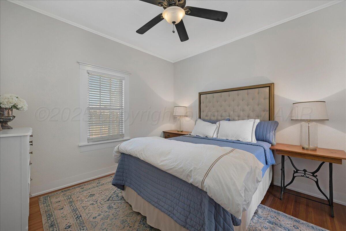 2007 6th Avenue Canyon, TX 79015 - Photo 12 of 33 a bedroom with a bed chandelier and a window